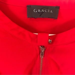 A red Gracia (brand) blouse with puffy long sleeves. In good condition.